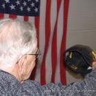Old World War II veteran takes off his hat to salute the American flag. Or did he? LOL...